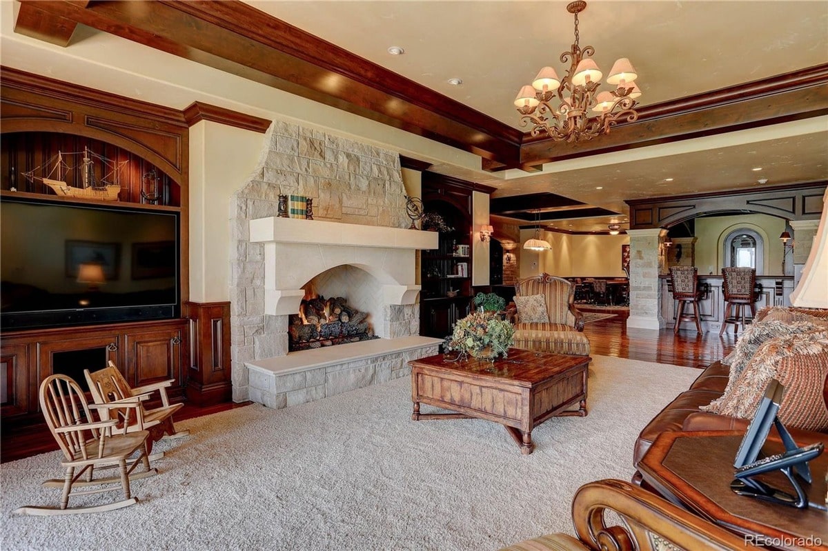 Designed for both entertainment and relaxation, this spacious family room offers a comfortable seating area centered around a cozy fireplace. Built-in cabinetry and a large screen TV provide ample space for family gatherings and leisure activities.