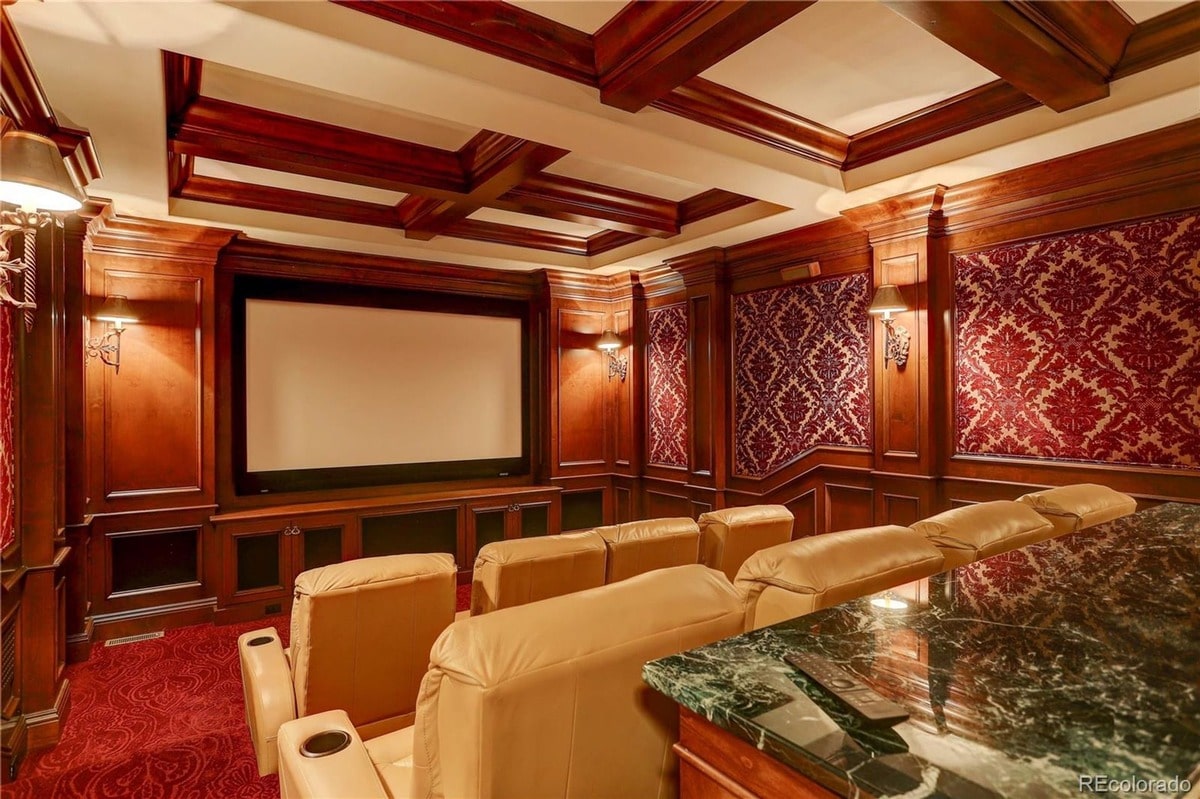 This opulent home theater offers a luxurious and immersive cinematic experience, featuring plush seating and rich wood paneling. The room's elegant design and state-of-the-art technology create a sophisticated and comfortable entertainment space.