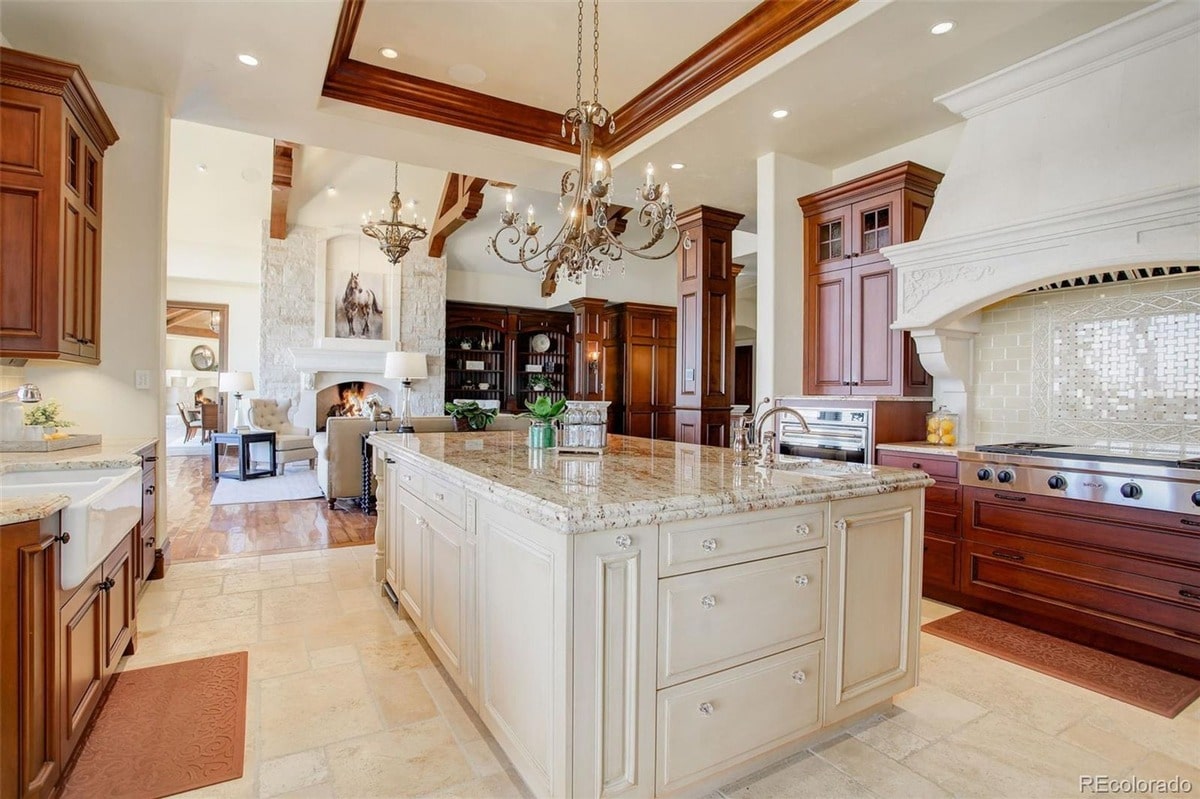 High-end materials such as granite countertops and rich wood cabinetry define the luxurious feel of this gourmet kitchen. The combination of warm tones and elegant details creates a sophisticated and inviting space.