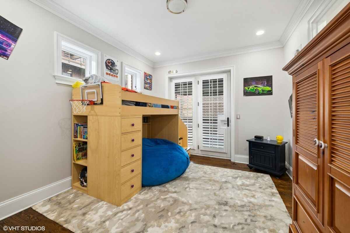 Children's room includes a loft bed with built-in storage, a bean bag chair underneath, small windows, and double glass doors with plantation shutters.