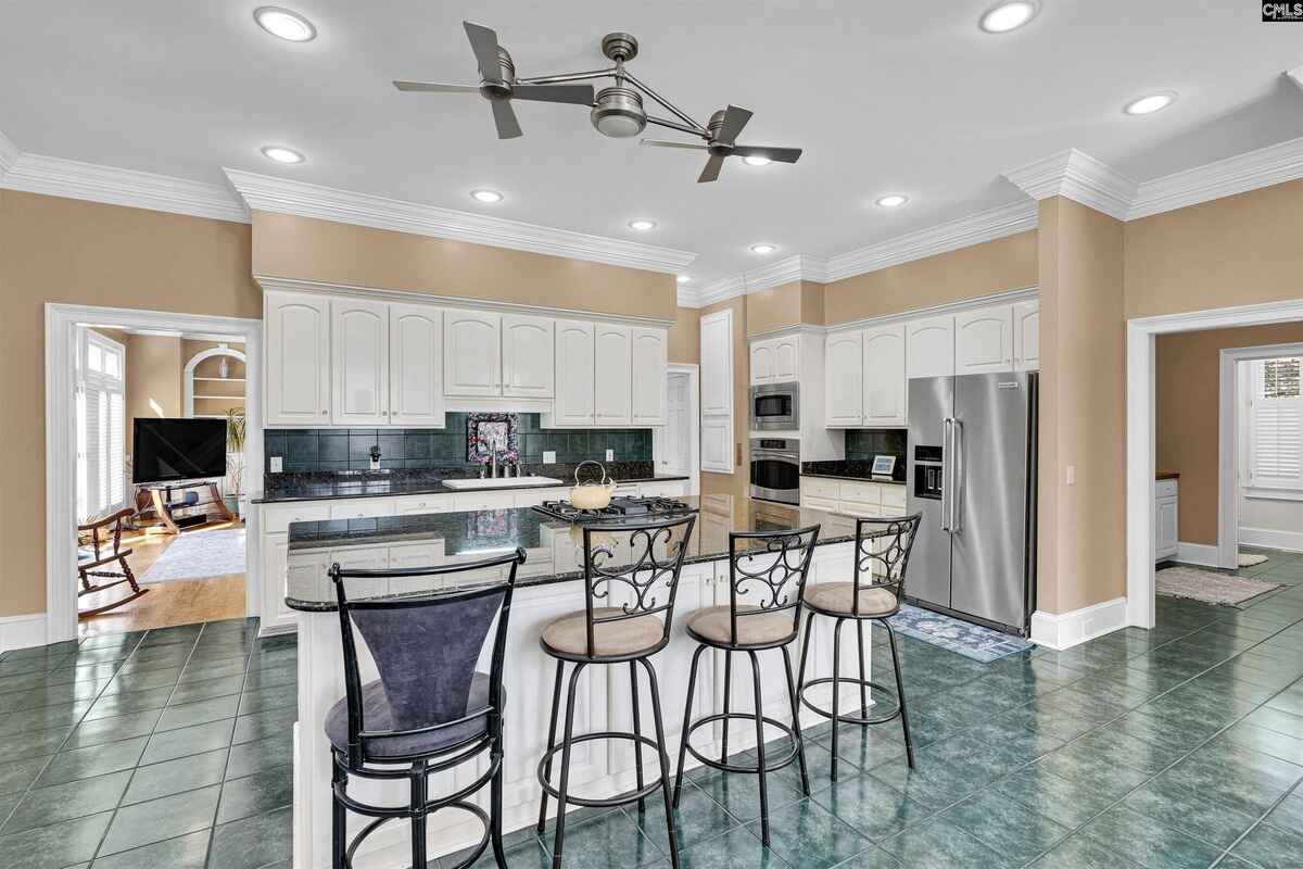 Open-concept kitchen showcases a center island, stainless steel appliances, and a spacious layout.