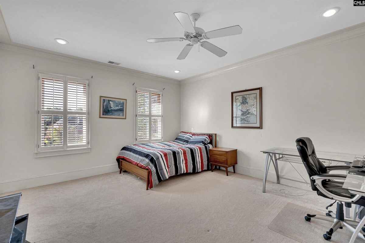 Bedroom setup includes a twin bed, desk space, and natural light from dual windows.