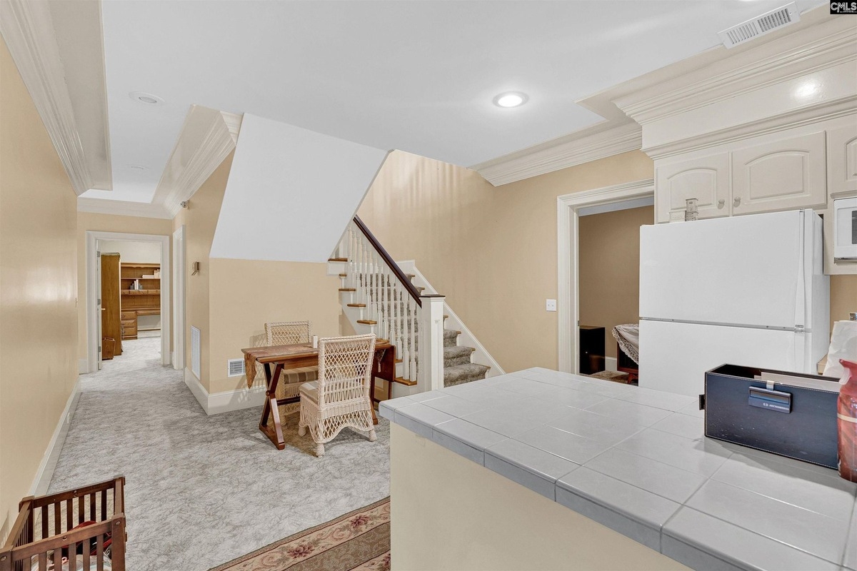 Upstairs hallway with a railing overlooking the lower level and access to adjacent rooms.