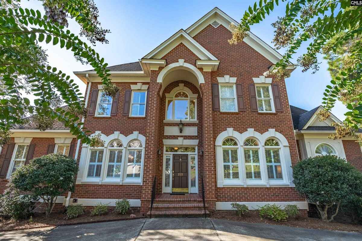 Closer perspective of the front elevation emphasizing detailed brickwork and arched windows.