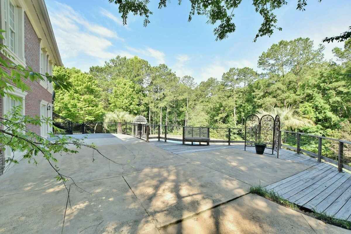 Spacious outdoor patio overlooks the wooded backyard with plenty of open space for relaxation.