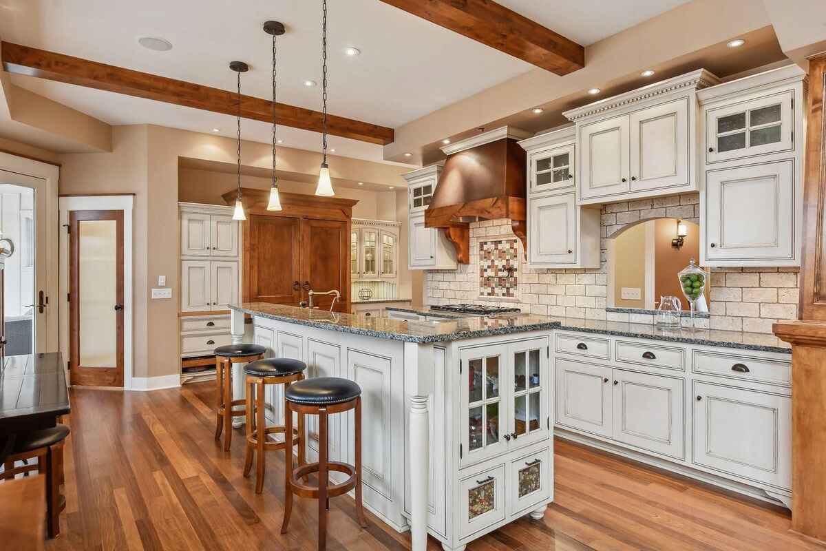 A wide view of the kitchen and dining space with natural wood finishes and modern lighting.