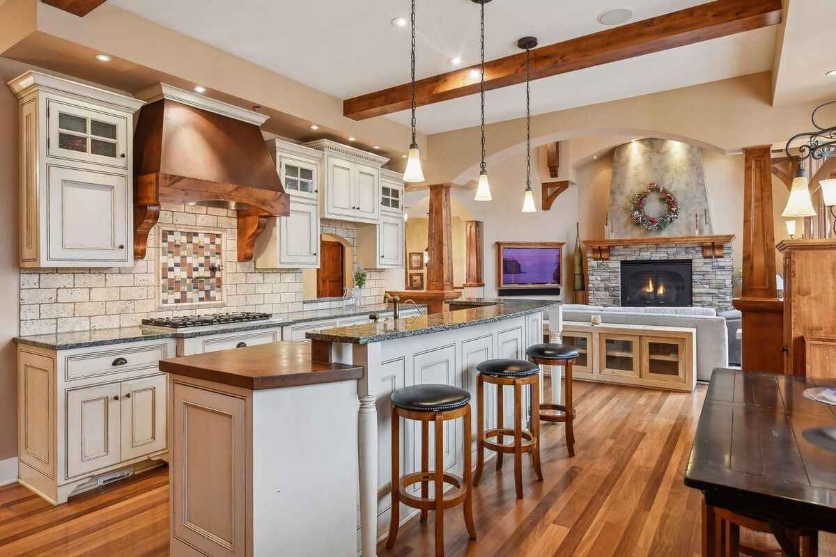 Another angle of the kitchen reveals additional cabinetry, built-in appliances, and a farm-style sink.