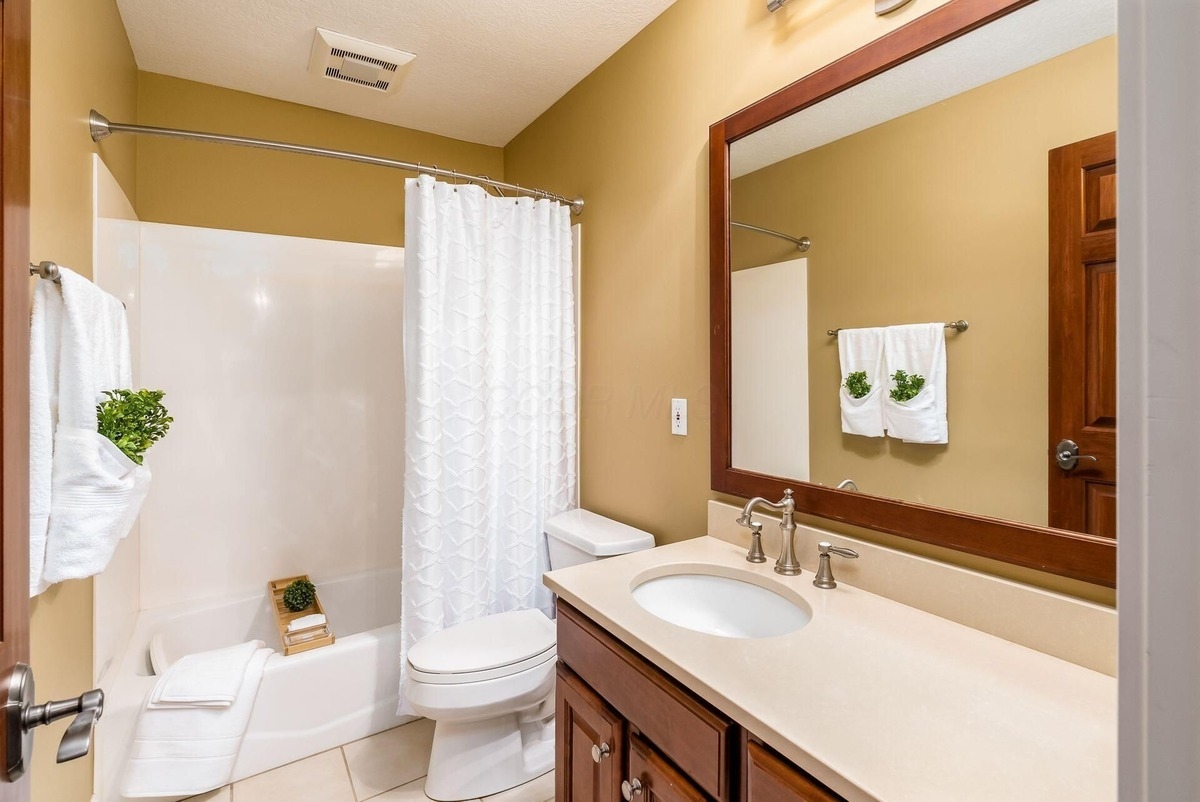 Bathroom with a bathtub-shower combination and a granite-topped vanity. Bathroom with a bathtub-shower combination and a granite-topped vanity.