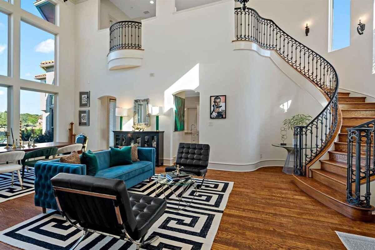 A two-story living space with large windows and elegant interior details.