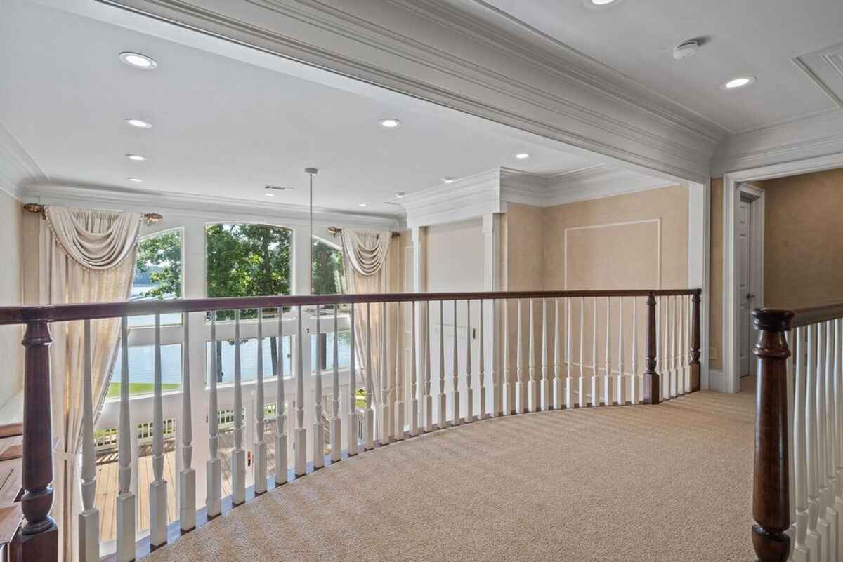 Outdoor deck space connected to the porch with railings and scenic views.