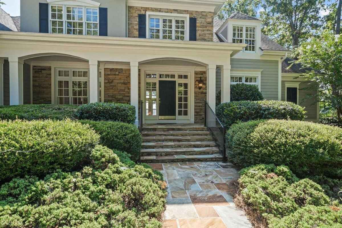 Stone-accented entry with stairs leading to a covered front porch.