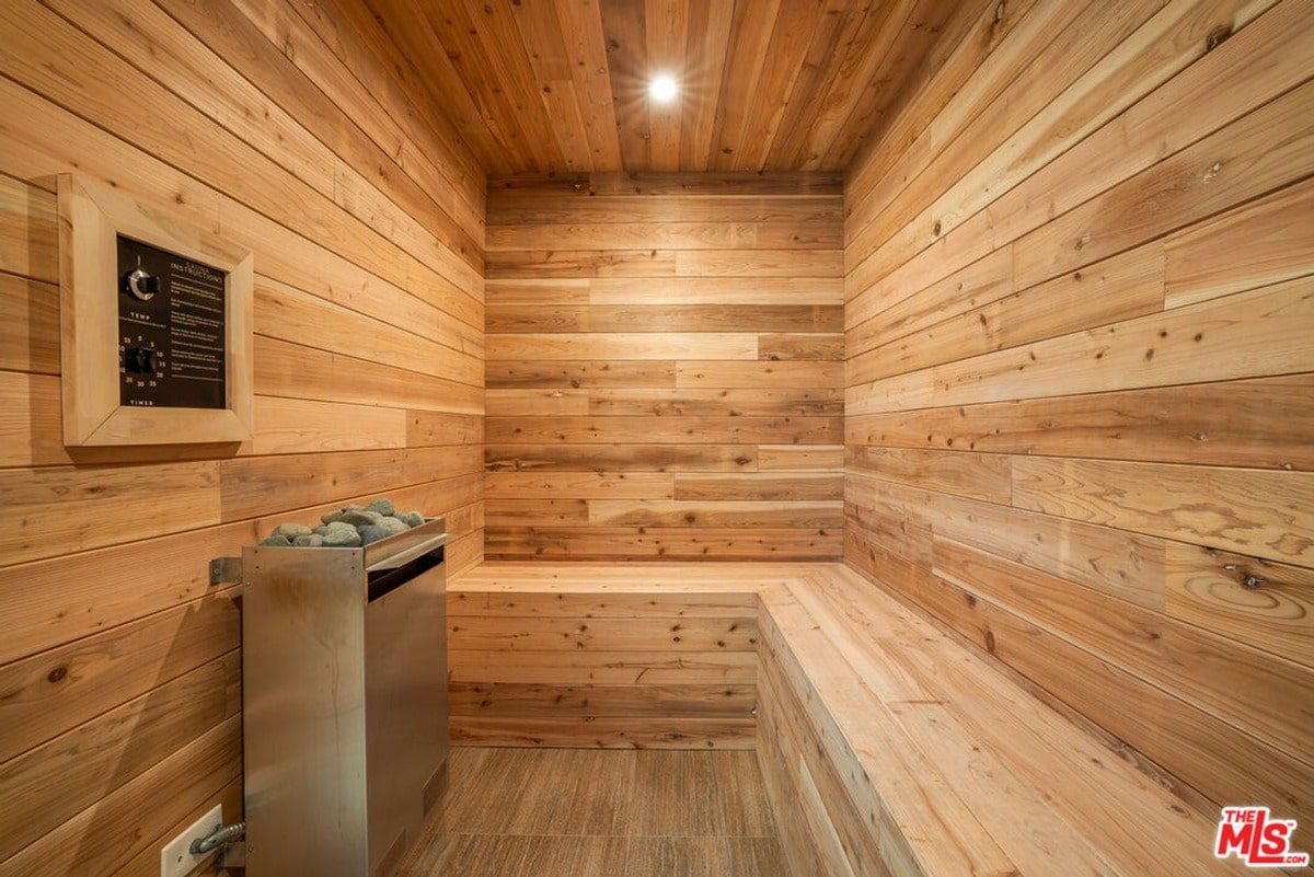 Crafted from natural wood, this sauna exudes a sense of rustic elegance, its warm tones and simple design promoting a feeling of wellbeing. The integrated controls and comfortable bench provide a luxurious and convenient experience for those seeking respite and rejuvenation.