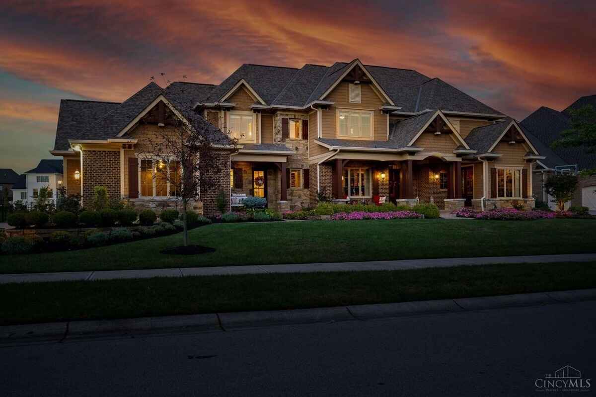 Twilight photo highlights the home's exterior with warm lighting against a vibrant sky.