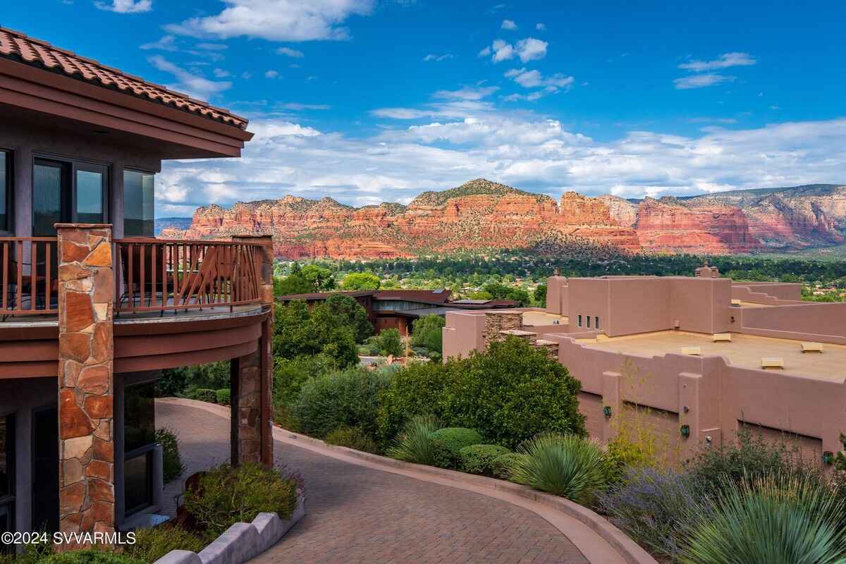 Balcony view showing red rock formations and surrounding desert vegetation.