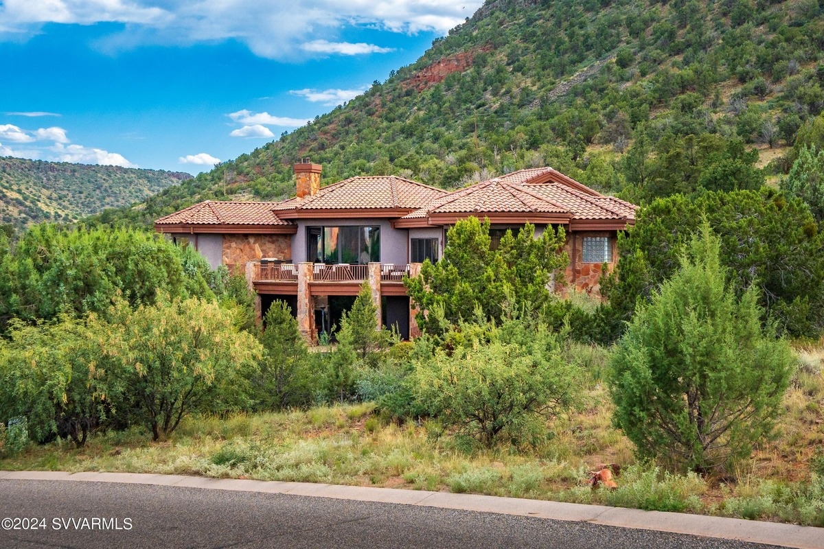 A view of the house surrounded by greenery, blending into the natural landscape.