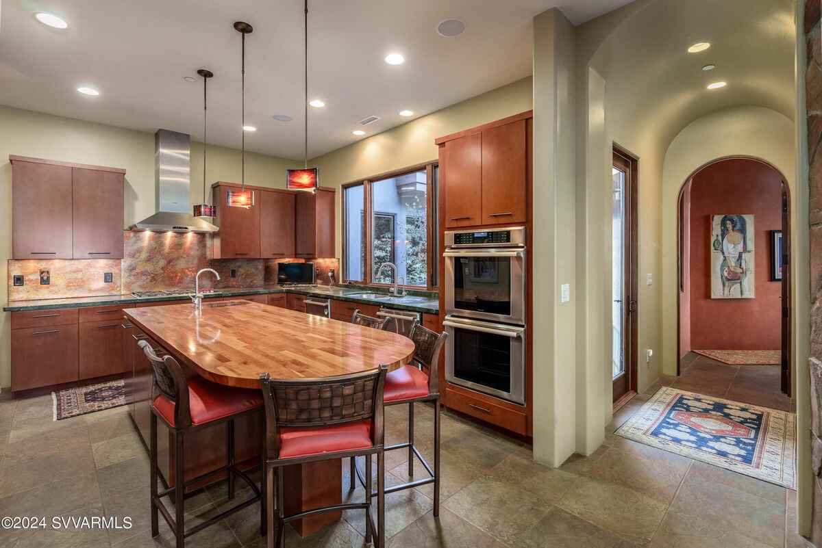 Kitchen with a central island, modern appliances, and ample natural light from nearby windows.