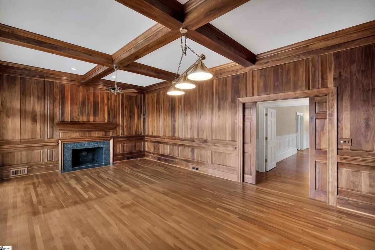 Luxurious room with custom wood finishes and a cozy fireplace.