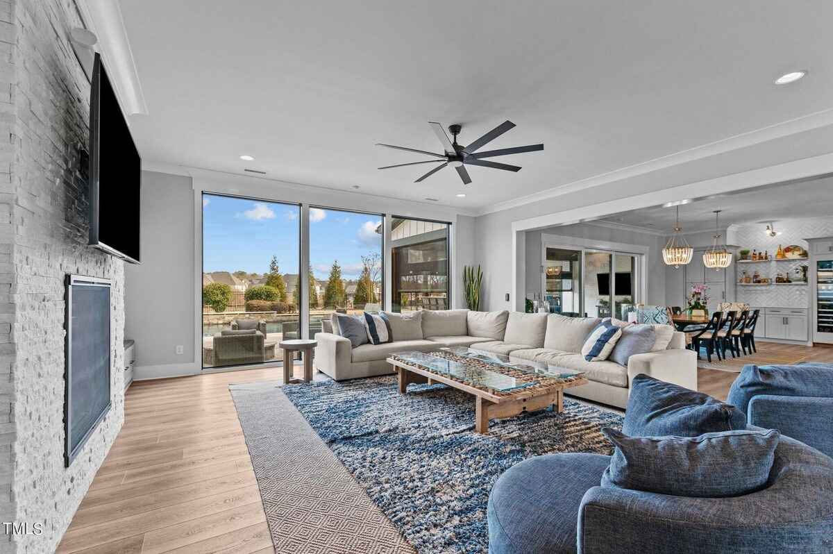 Open living and dining area with view of outdoor patio and pool.