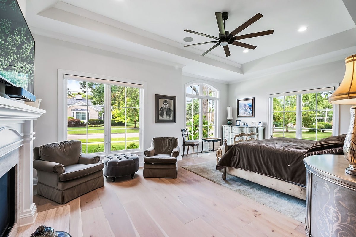 This expansive master bedroom, bathed in natural light, offers a sanctuary of tranquility.