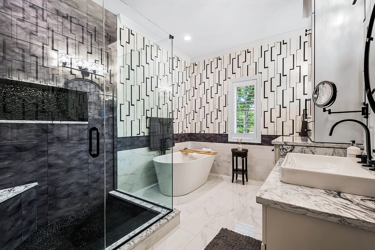 This luxurious master bathroom, captured from a wide-angle perspective, exudes an air of sophisticated elegance. 