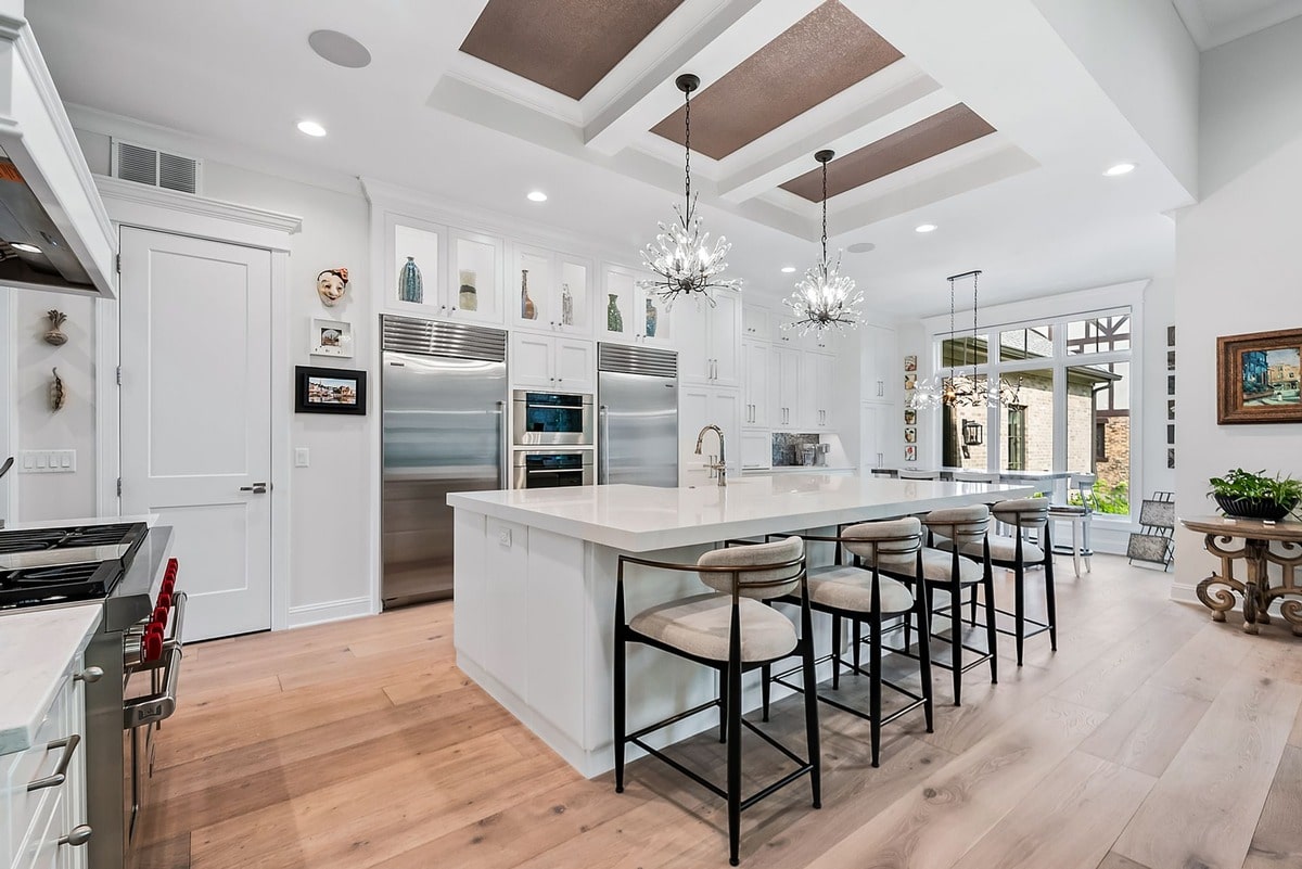 This open-concept living space, bathed in natural light, showcases a seamless flow between the living room and kitchen. 