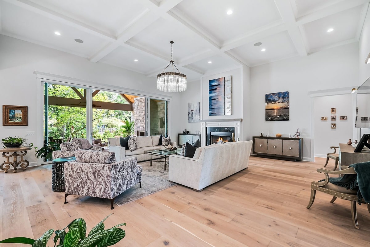 This open-concept living space, bathed in natural light, showcases a seamless flow between the living room and kitchen.