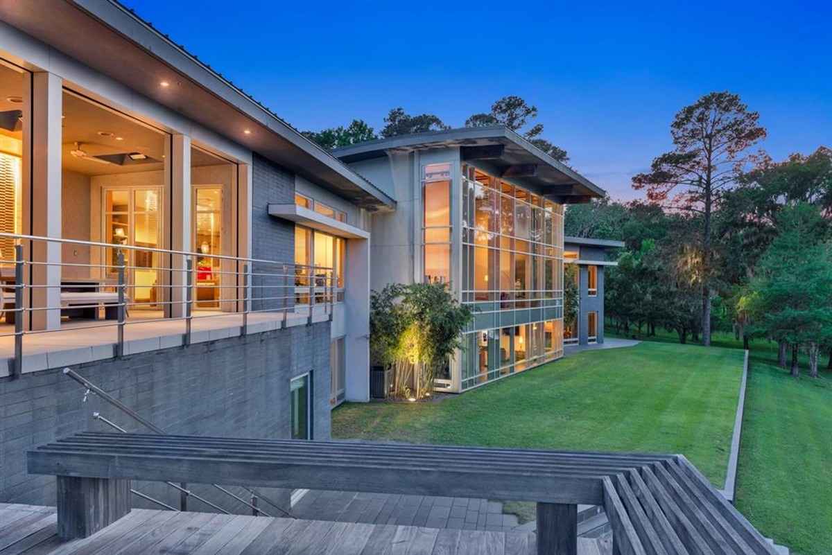 The house glowing warmly at night with modern architectural highlights.