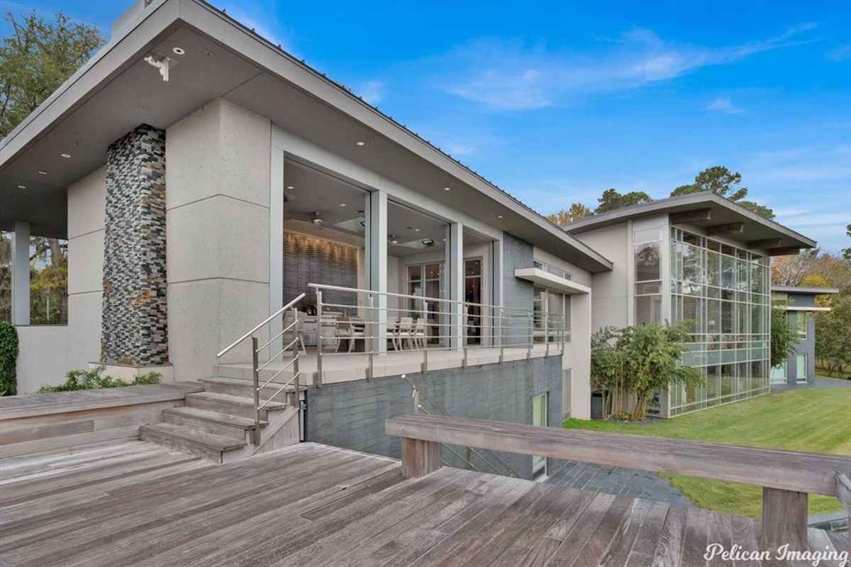 An exterior view of the house with wooden decks and contemporary architectural elements.