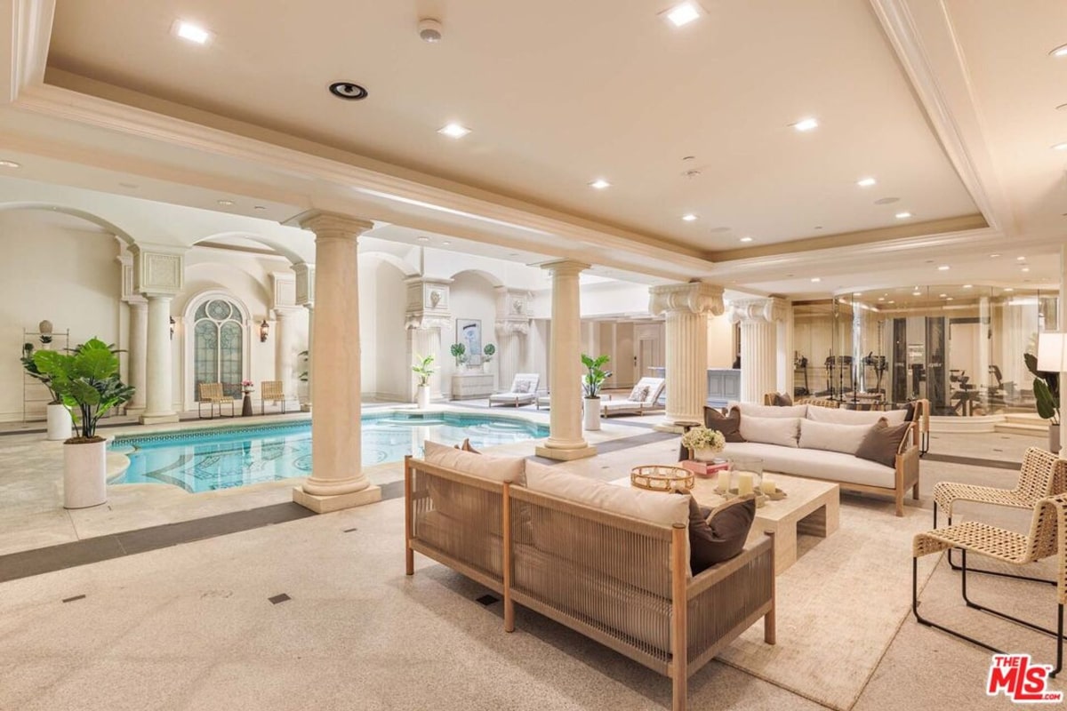 Indoor pool with a seating area.