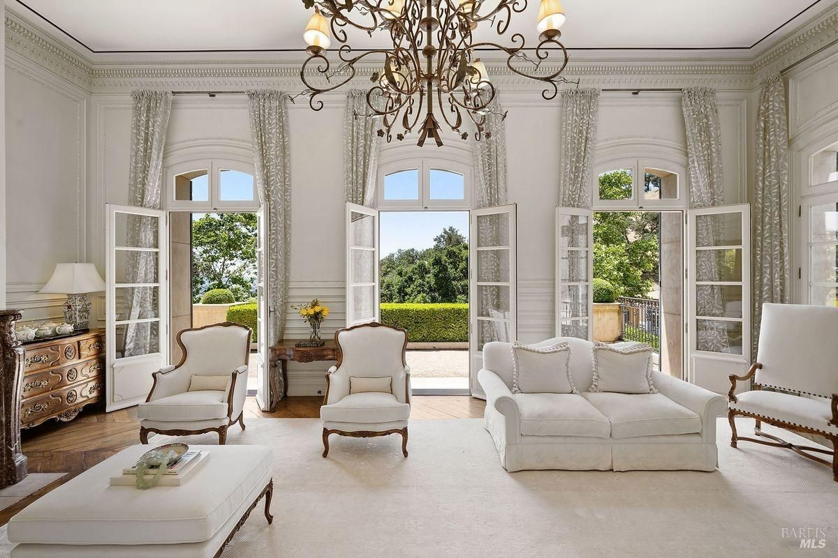 Living room with chandelier and white sofas