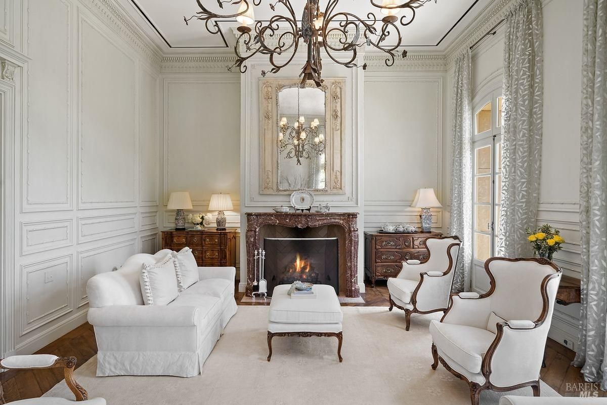 Living room with fireplace, white sofas and rectangular center table