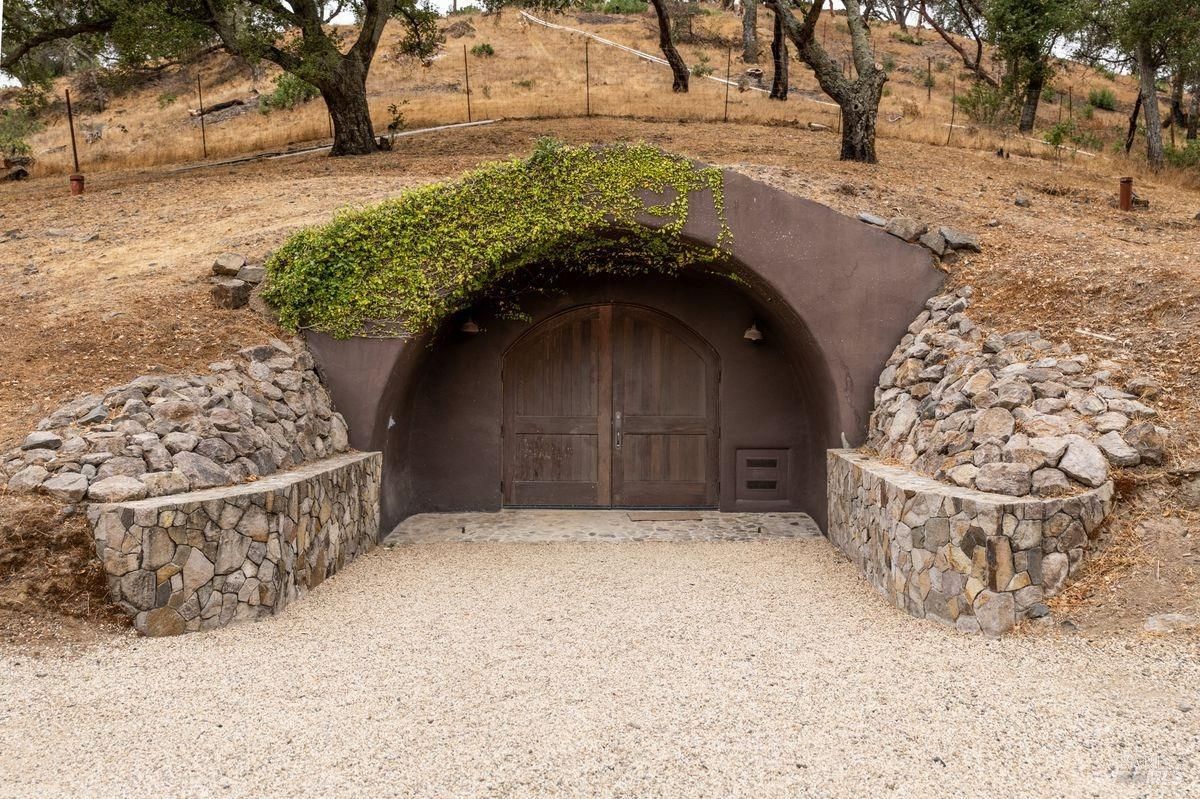 The entrance is arched and has dark-colored double doors