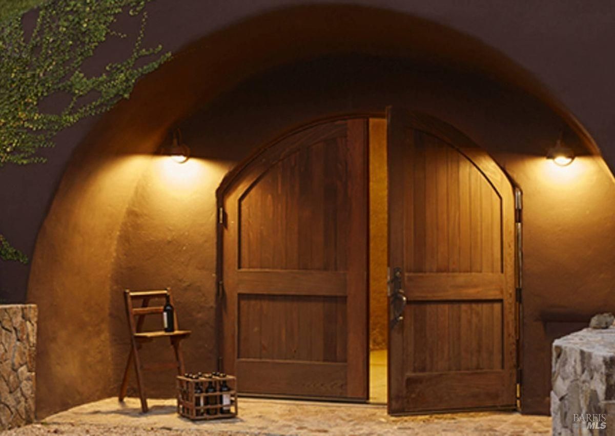 The entrance is arched and has dark-colored double doors