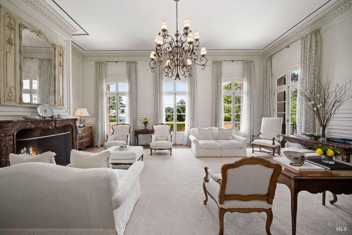 Living room with chandelier and white sofas