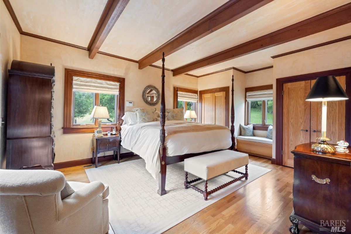 Master bedroom with a luxurious bed, natural wood finishes, and soft ambient lighting.