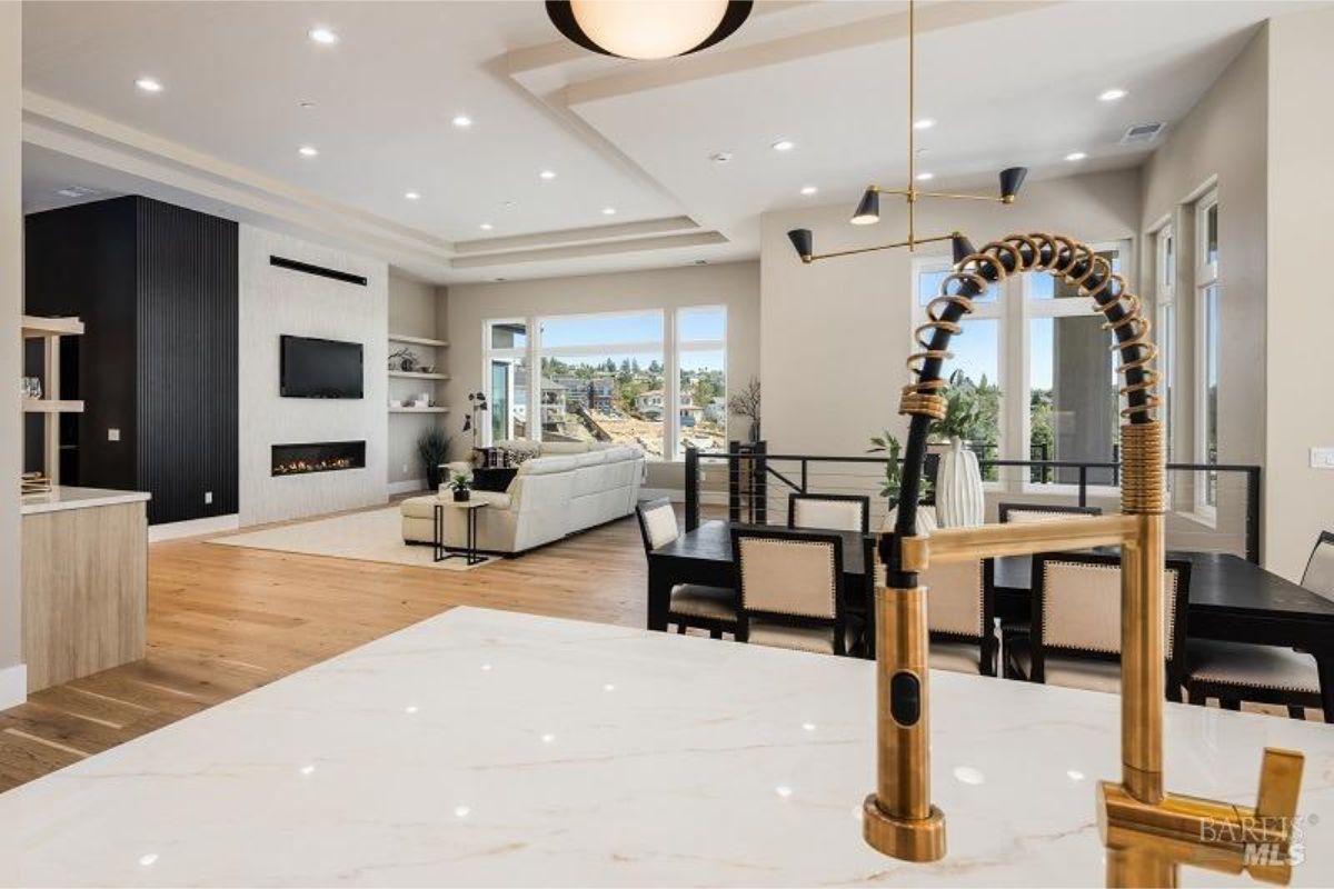 Dining area flows seamlessly into the kitchen, highlighting a bright and airy space with scenic outdoor views.