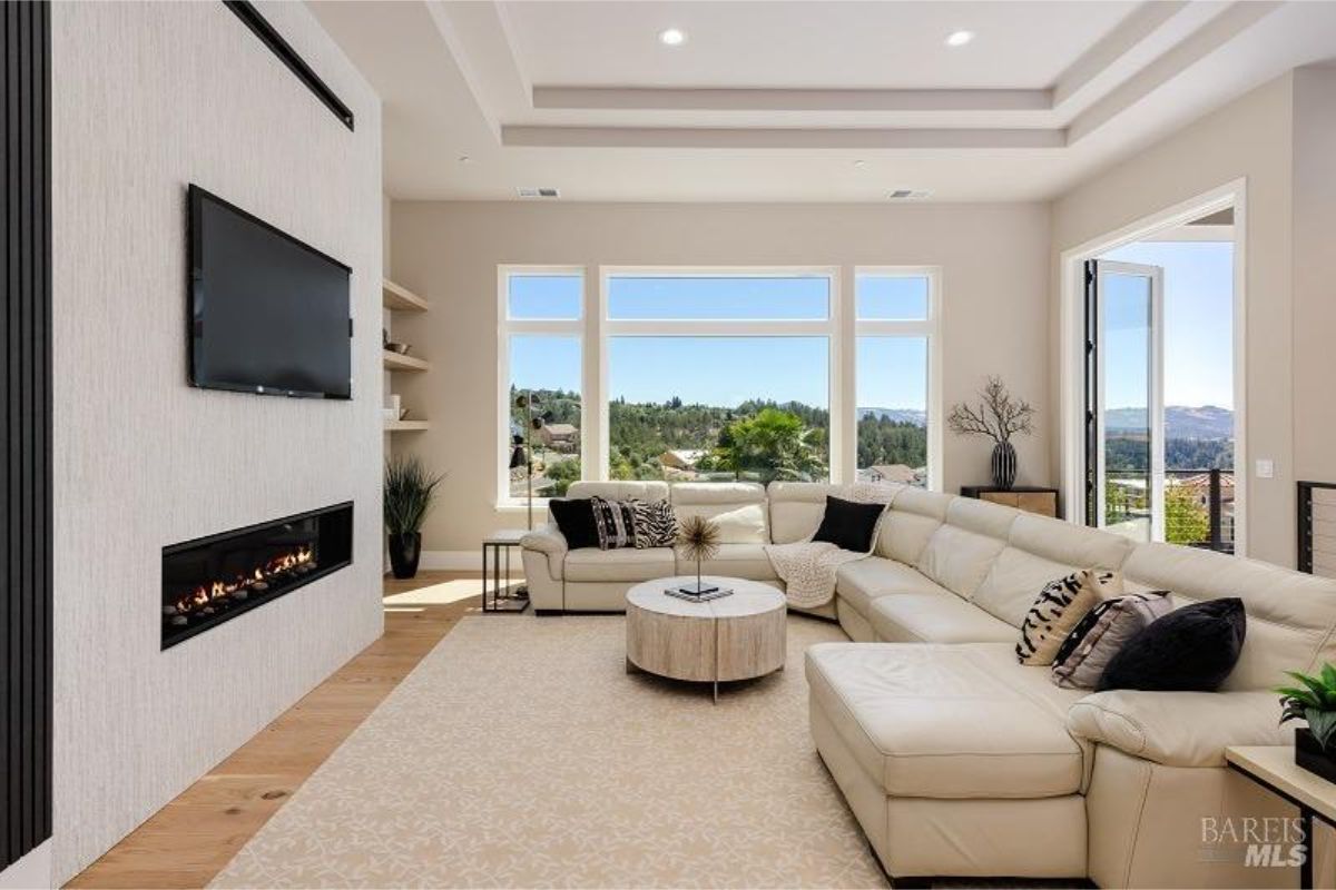 Bright living room with large windows showcasing scenic outdoor views.