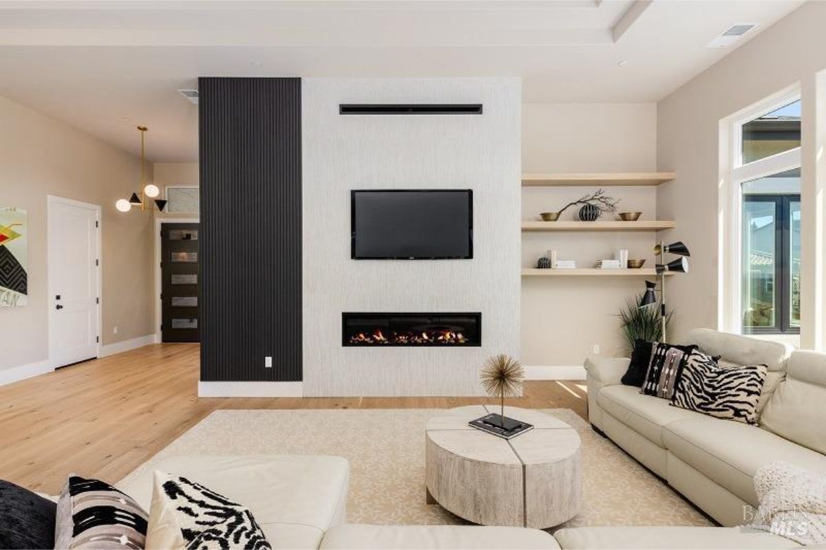 Stylish fireplace wall with integrated shelving in a sophisticated living area.