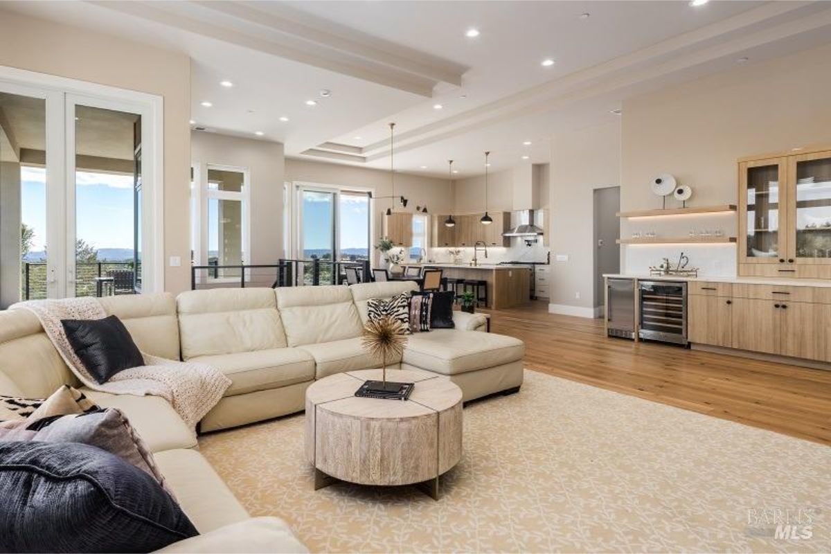 Open-concept living space connecting a cozy lounge area to the sleek kitchen.