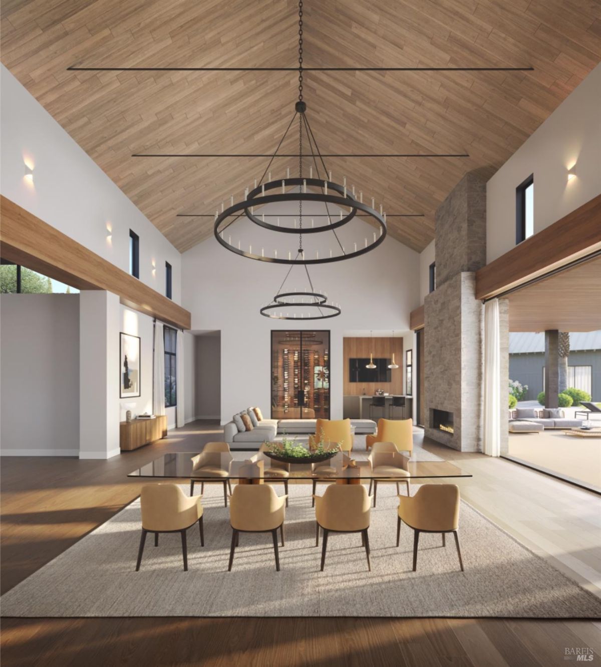 Dining room view focusing on a table with chairs, framed by high ceilings and natural light through floor-to-ceiling windows.