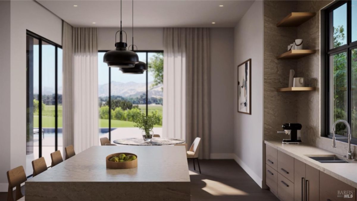 Kitchen with a large island, modern pendant lights, and minimalist shelves with natural outdoor views.