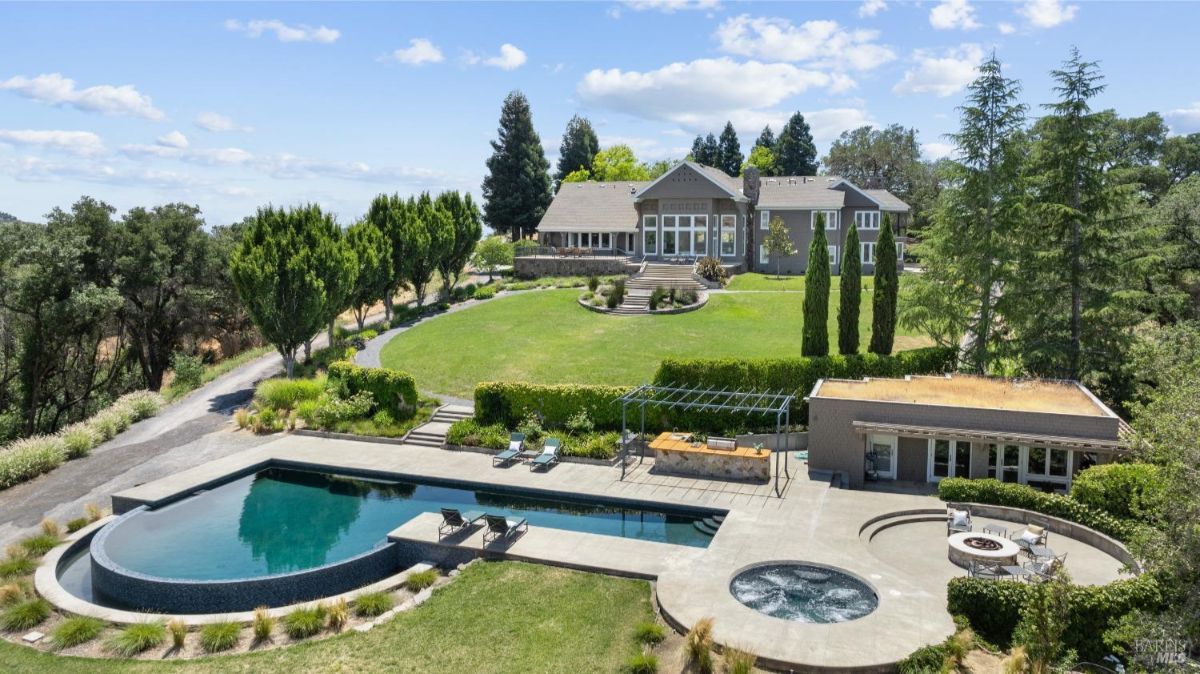 Features an elegant estate with a large pool and meticulously landscaped grounds.