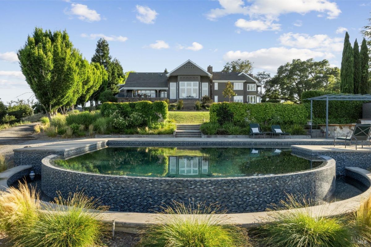 The infinity pool and surrounding landscape provide a luxurious outdoor living space.