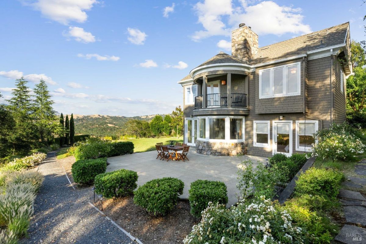  Spacious backyard with a patio, outdoor seating, and scenic views of the surrounding greenery.