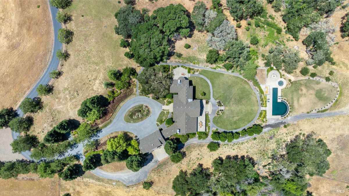 An aerial view showcases the estate's expansive grounds, driveway, and picturesque layout.