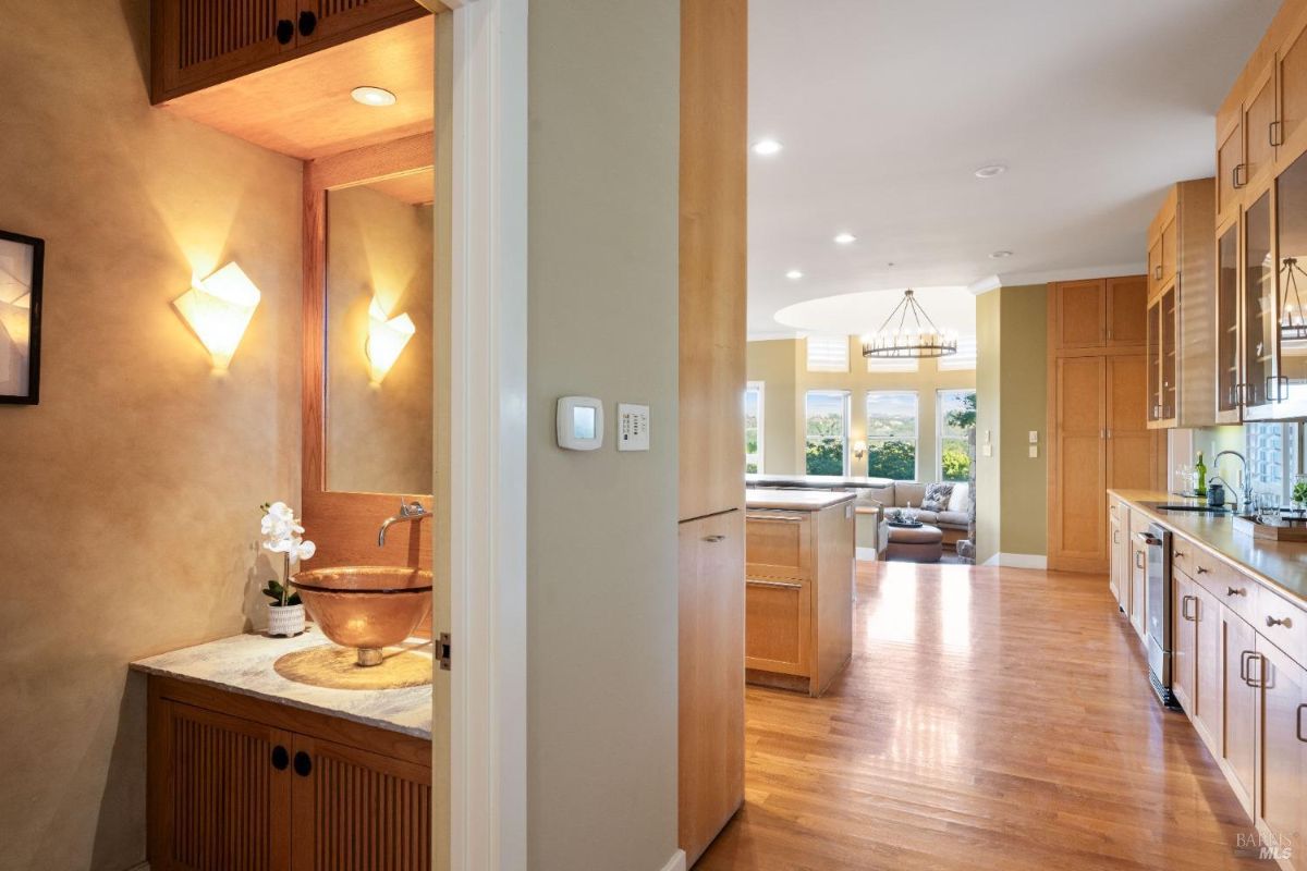 Cozy powder room with a copper sink, warm lighting, and wood accents.