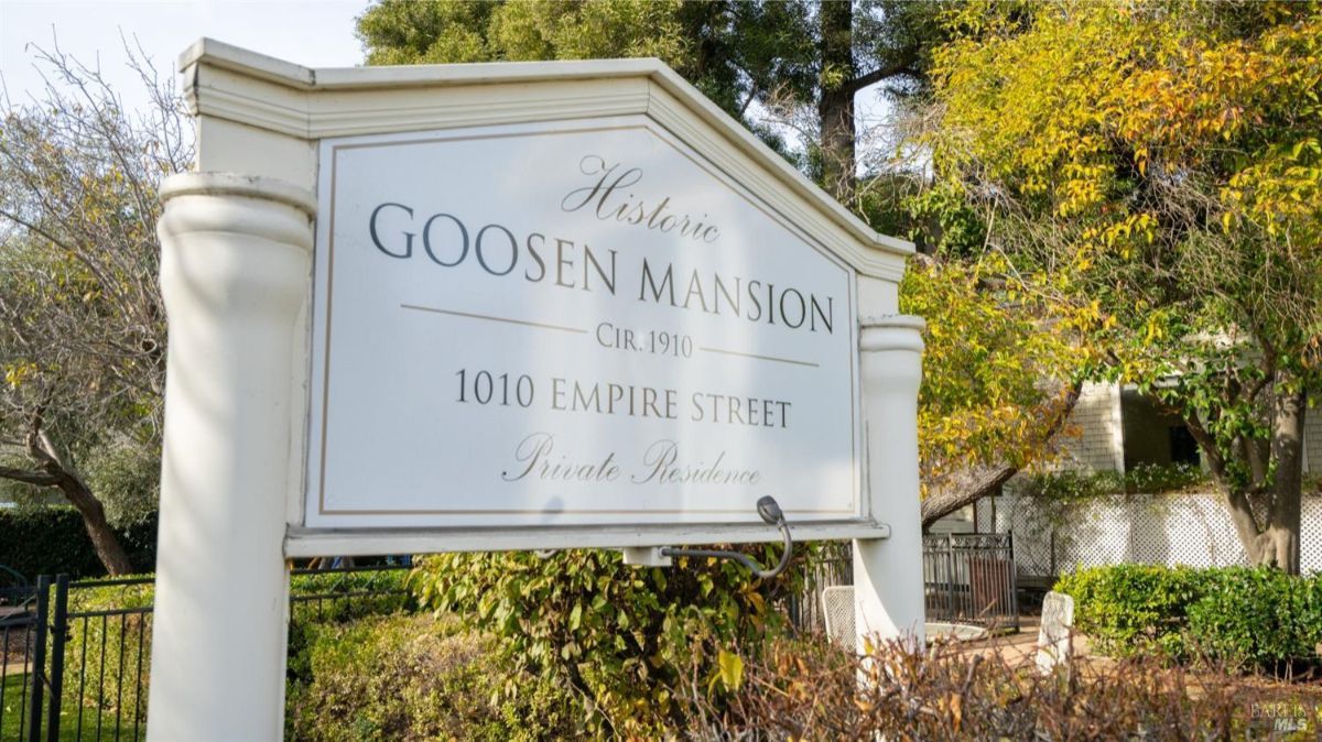 A historical marker for the "Historic Goosen Mansion," built in 1910. The sign emphasizes the historical significance of the property, which is designated as a private residence.