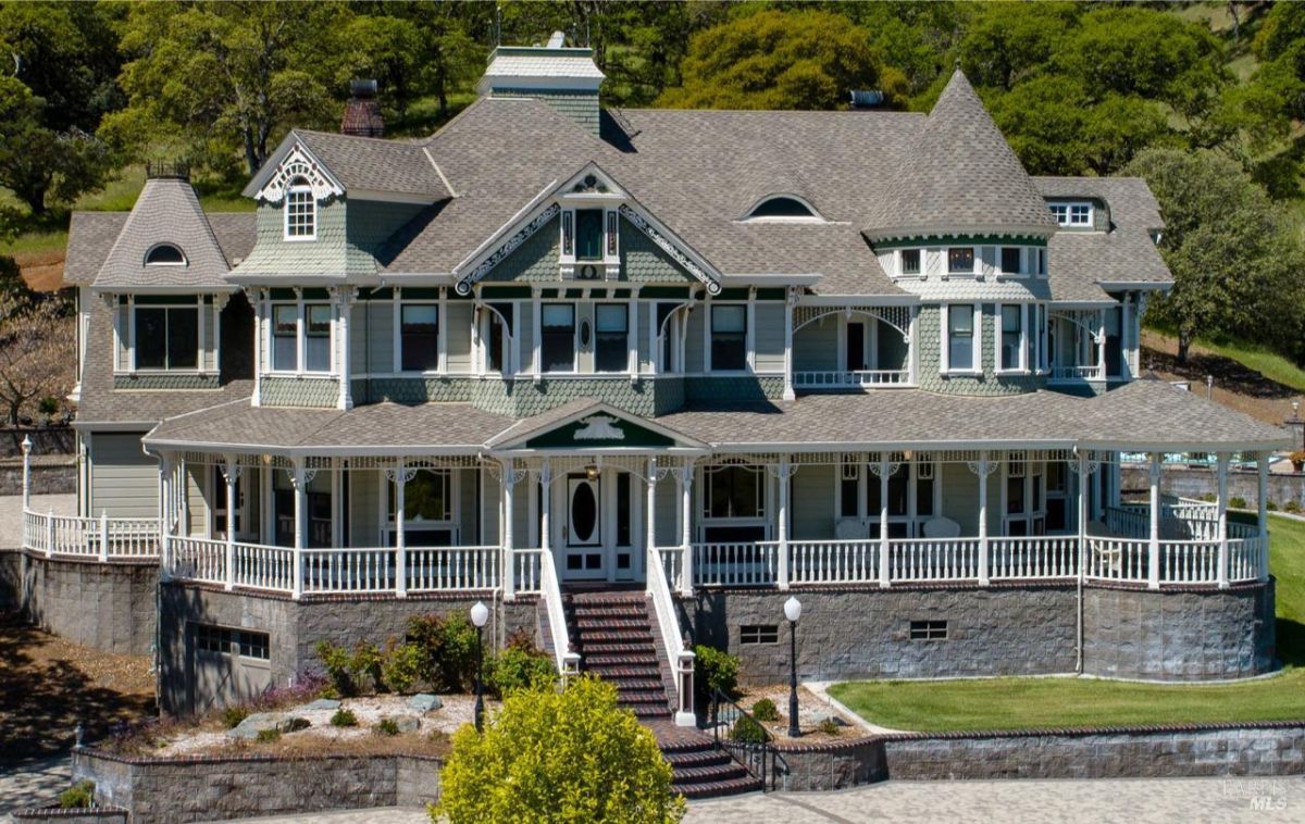 Grand Victorian-style mansion featuring intricate architectural details and wraparound porches.