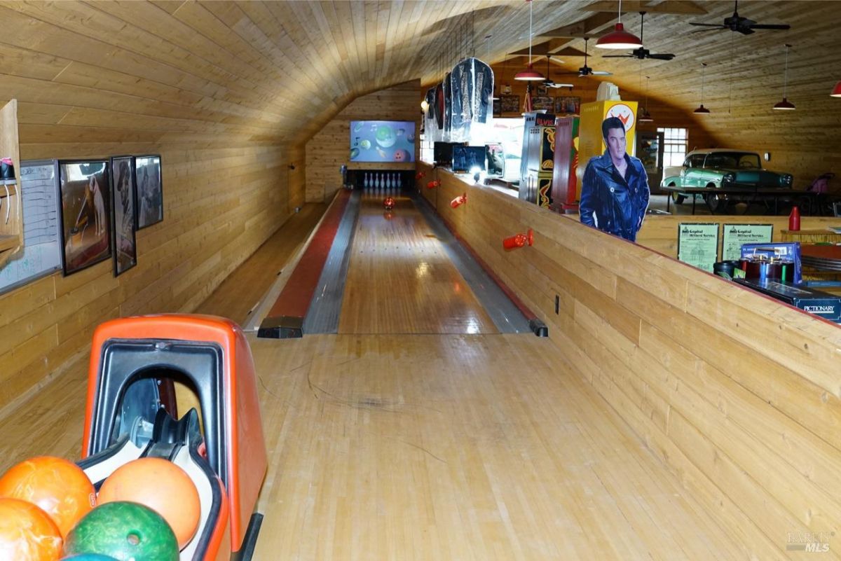 Bowling alley with colorful bowling balls and wooden lanes.