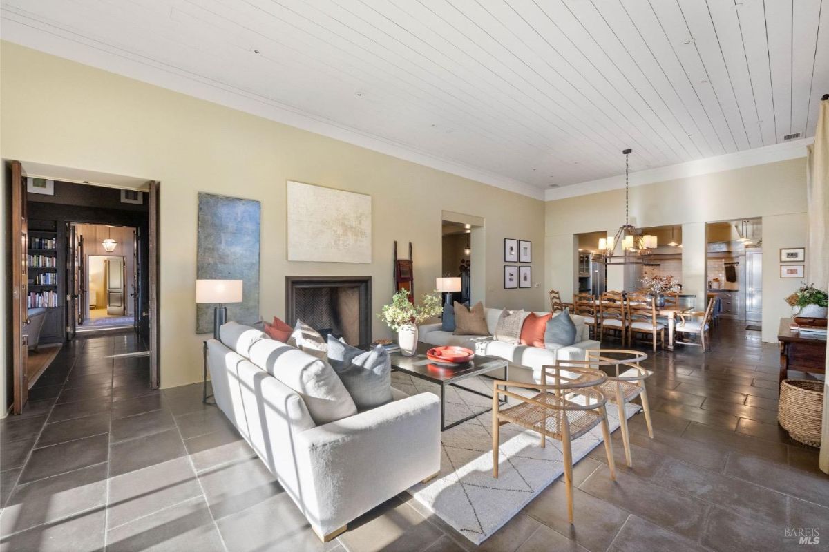 Open-plan living and dining area with a fireplace and access to the kitchen.